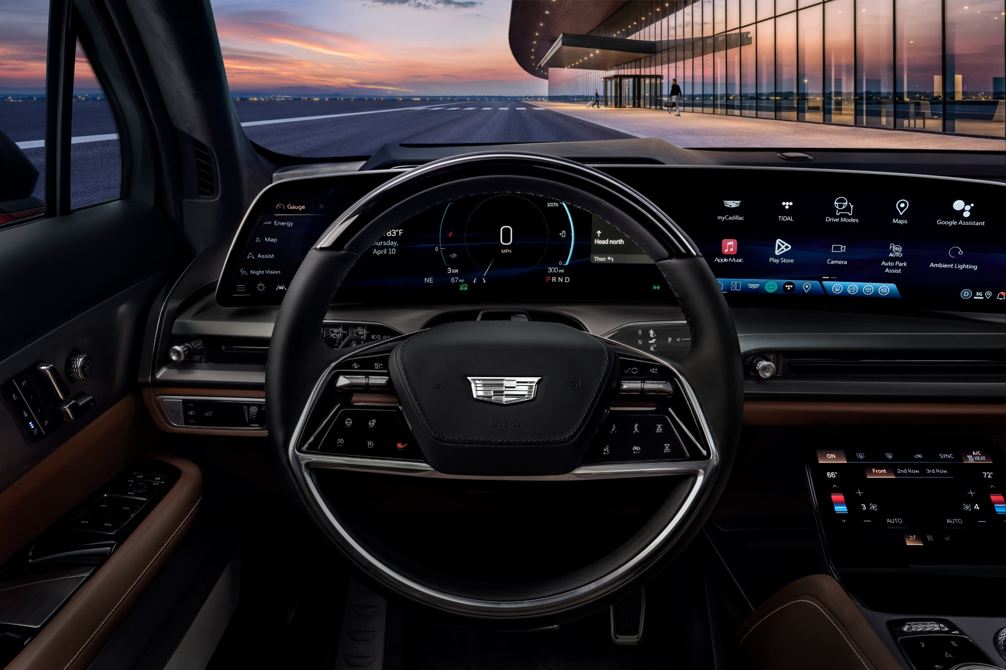 Escalade IQ cockpit at dusk: steering wheel, driver display and centre console, with a terminal building beyond the windscreen.